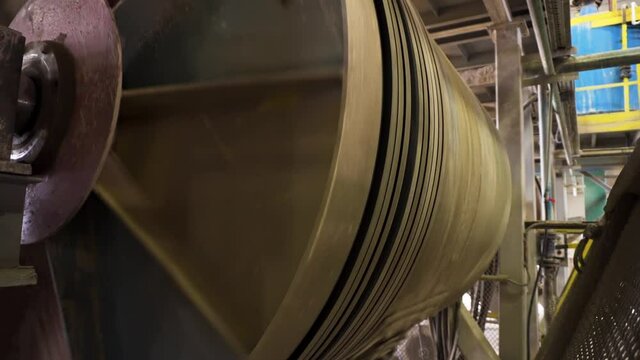View of the large dressing mill in the mine factory. Stock footage. View inside of the construction materials production factory with a spinning machine.