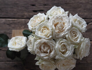 Floral card. Beautiful white rose on a wooden background.
