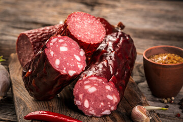 salami sausage on a old wooden table. farm organic food. Food recipe background. Close up