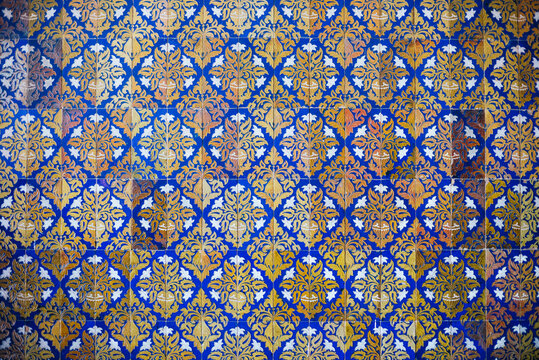Wall texture of old yellow and blue tiles from Seville, Andalusia. Horizontal photography