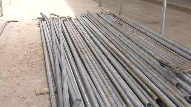 Pile of many different sizes of building material galvanised steel on the floor.
