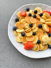 Freshly cooked pancake cereal served with fresh berries.
