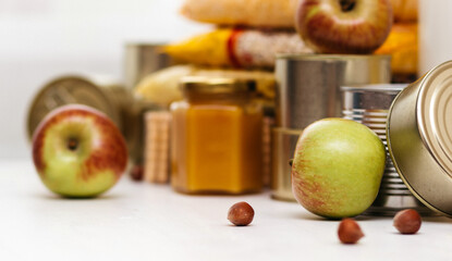 Various canned goods, pasta and cereals on a white table. Food donation or food delivery concept.