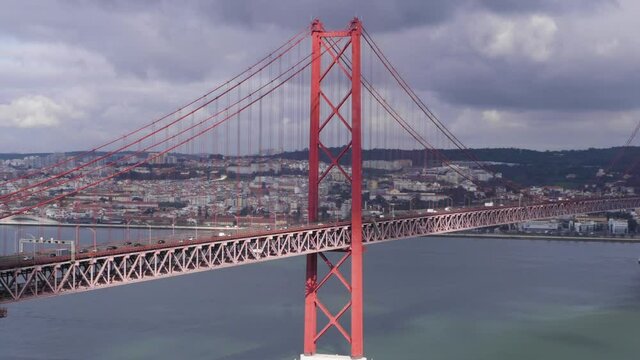 Medium Shot of striking Golden Gate-style suspension bridge with moving traffic that links Lisbon with Almada.