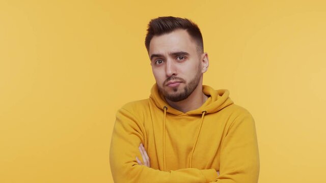 Expressive young man over vibrant background. Studio portrait of borred person.