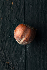 Hazelnut on a Black Wooden Surface