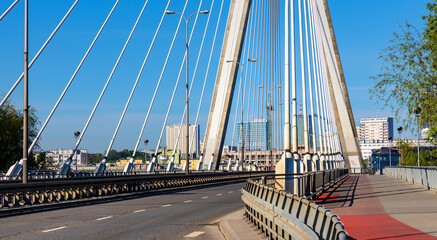 Fototapeta na wymiar Panoramic view of Swietokrzyski Bridge - Most Swietokrzyski - with Vistula river with Srodmiescie city center of Warsaw, Poland in background