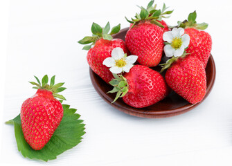 wooden dish with strawberries. white background.