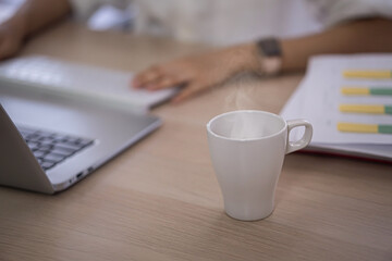Fototapeta na wymiar hot coffee cup on computer table