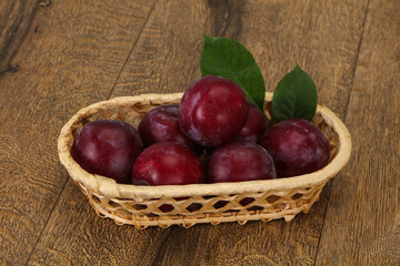 Plum heap in the wooden basket