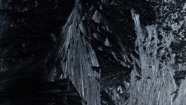 Ice Forming process 4K, Window freezing on dark background. Ice growind with dots and spikes