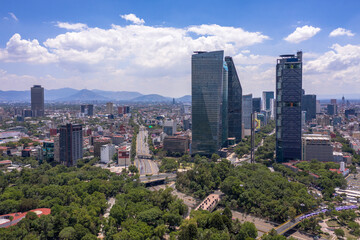 Aerial panoramic view of the tallest buildings in Mexico City with a blue sky as background.