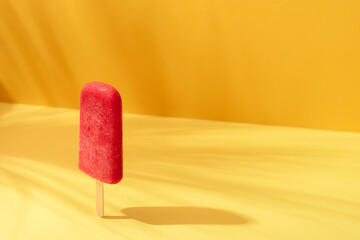 Fruit ice cream popsicle. Strawberry ice cream on a stick