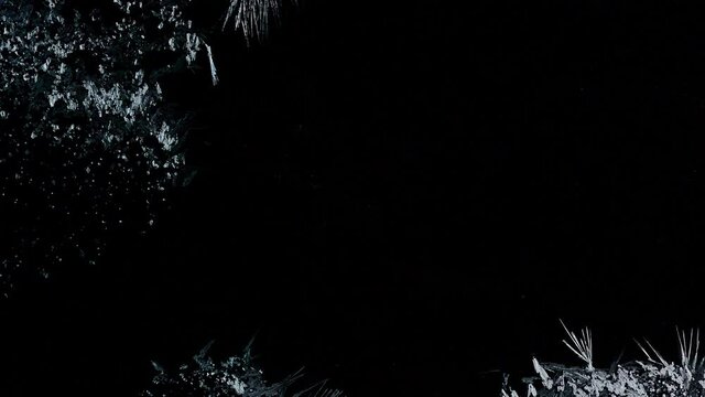 Ice Forming process 4K, Window freezing on dark background. Ice growind with dots and spikes