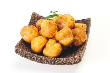 Sweet tasty profiteroles heap in the bowl