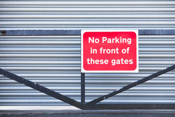 No parking in front of gate 24hr access required sign