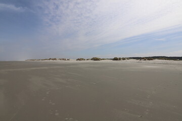  Nice view over a wide windy beach. Photo was taken on a sunny day with a blue sky.