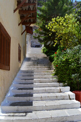 Fototapeta na wymiar Stairs going up next to a house in historic old town of Nafplio, Greece.