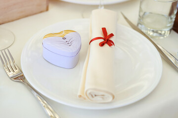 Wedding bonbon sweets in metal white box on the plate in restaurant