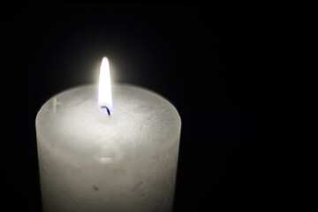 Candle flame close-up on a black background.