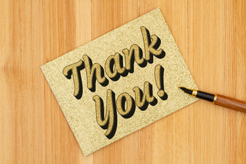 Thank you gold greeting card with a pen on a desk