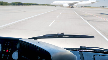 View from the airport bus shuttle on airplanes driving on airport runway