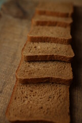 Sliced ​​bread on a wooden background.