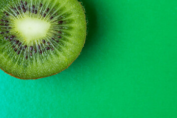 kiwi on a green background. Kiwi cutaway. Photo from above. Kiwi as a background. Exotic fruit