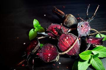 Organic roasted beetroots on dark background. 