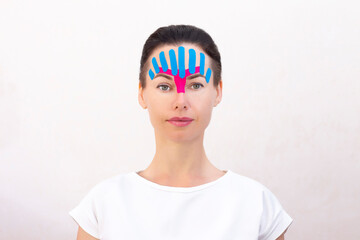 Face taping, close-up of a girls face with cosmetological anti-wrinkle tape. Face aesthetic taping. Non-invasive anti-aging lifting method for reduction of wrinkles