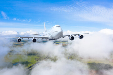 Airplane gains altitude flying through layered cumulus clouds, travel flight.