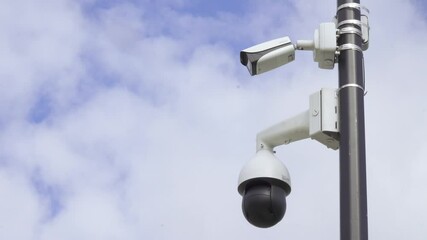 Security cameras on a pillar - Powered by Adobe