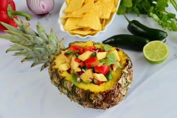 Homemade Fresh Pineapple Salsa in Pineapple Bowl. Served with Tortilla chips