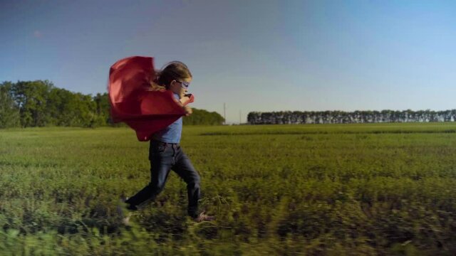 Little Girl Child In A Field In A Superhero Costume