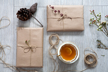 Various items for gift wrapping are on the table. Gifts already packed. Cone, wrapped books
