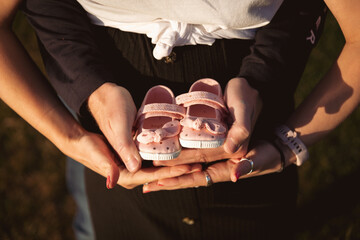 Pregnant couple outside at sunset. Happy family pregnancy