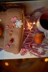 Photo for the New Year card. New Year's composition. View from above. Warm knitted scarf in purple. Tangerines lie on a scarf. Christmas composition with tangerines and a scarf.