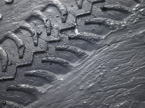 close up of SUV tyre tracks in grey mud