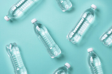 Pattern of plastic bottles with water on blue background. Top view. World water day. Copy space....