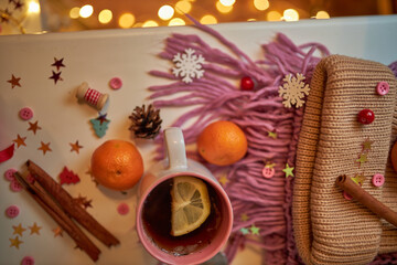 Photo for the New Year card. New Year's composition. View from above. Warm knitted scarf in purple. Tangerines lie on a scarf. Christmas composition with tangerines and a scarf.