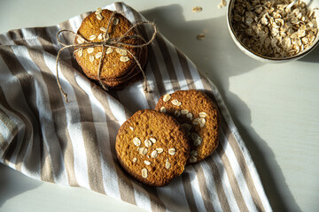 Homemade oatmeal cookies on white kitchen table.