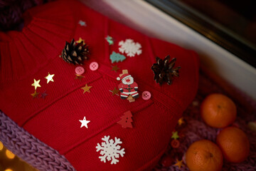 Photo for the New Year card. New Year's composition. View from above. Warm knitted scarf in purple. Tangerines lie on a scarf. Christmas composition with tangerines and a scarf.2021