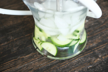 Colorful glass hookah water pipes with hoses on table, traditional shisha used for smoking in lounge bar. Various vibrant LED lights olluminating modern hookah setup.