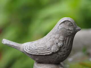 statue of bird on a birdbath