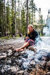 Fototapeta na wymiar woman relaxing by a campfire