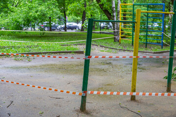 Red and white police line at the playground. The ban on visiting the territory