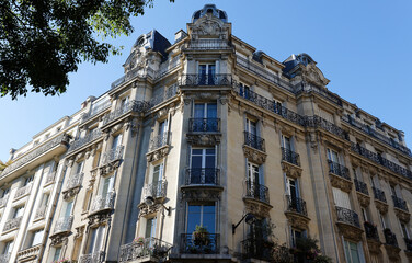 Obraz premium Traditional French house with typical balconies and windows. Paris.