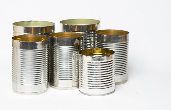 Empty metal cans against a white background