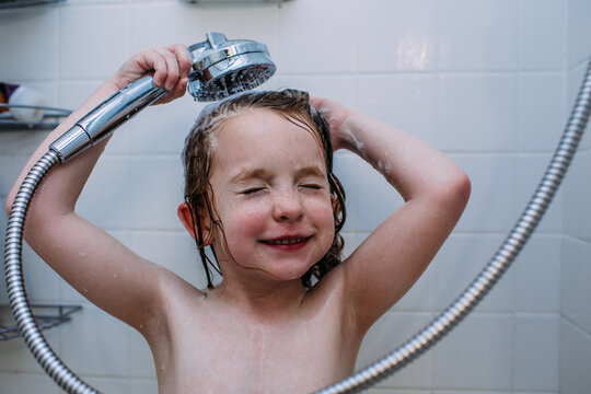 Close up of girl washing her hair with shower