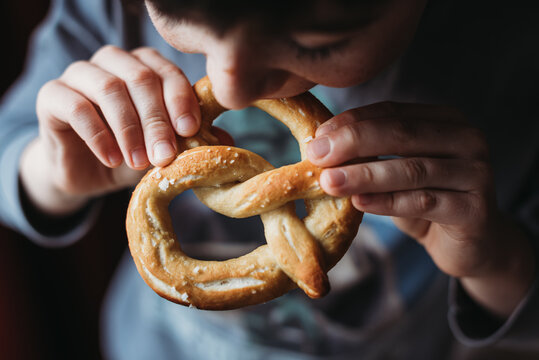 Close up of boy eating pretzel